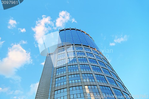Image of Office modern building against the evening sky with white clouds
