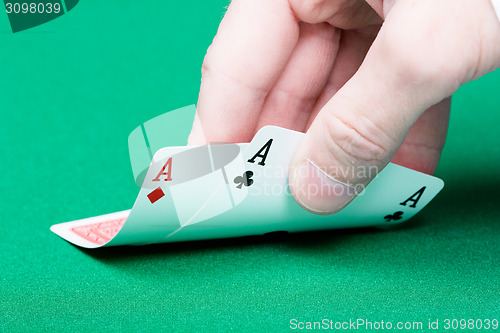 Image of card player. Male hand with cards