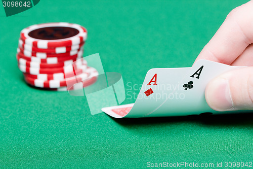 Image of card player. Male hand with cards