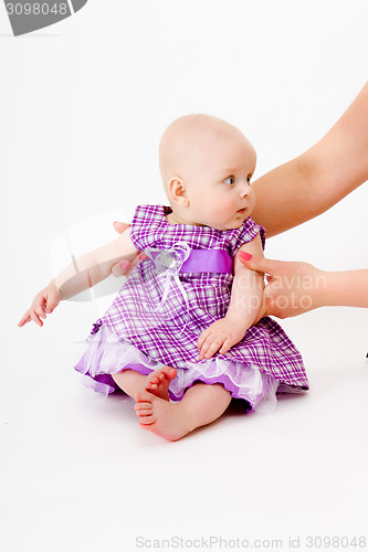 Image of baby girl in a dress. studio