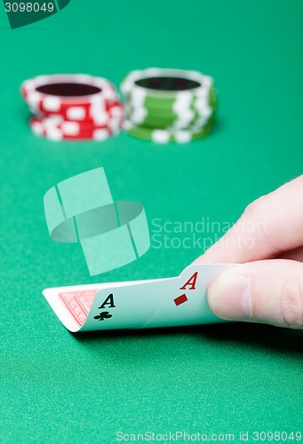 Image of card player. Male hand with cards