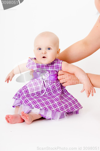 Image of baby girl in a dress. studio