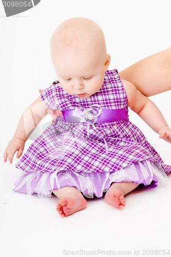 Image of baby girl in a dress. studio