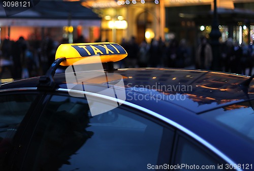 Image of Taxi sign at night 