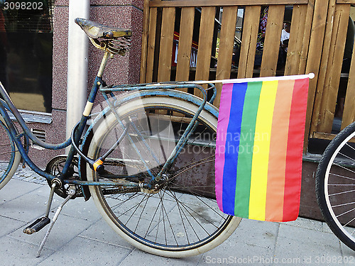 Image of Rainbow flag on a bicycle.