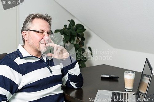 Image of Man working from home on laptop computer