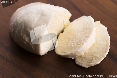 Image of Sliced mozzarella on wooden board 