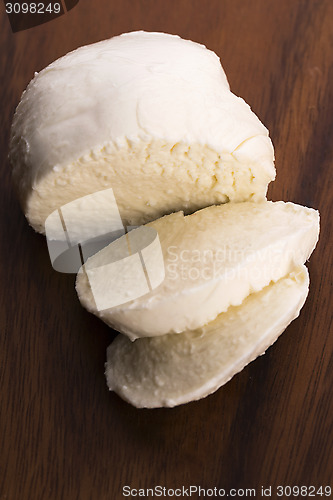 Image of Sliced mozzarella on wooden board 