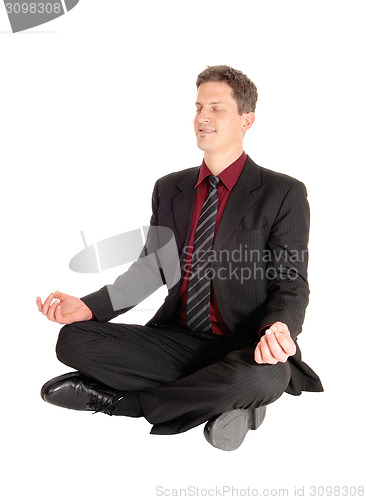 Image of Businessman doing yoga.