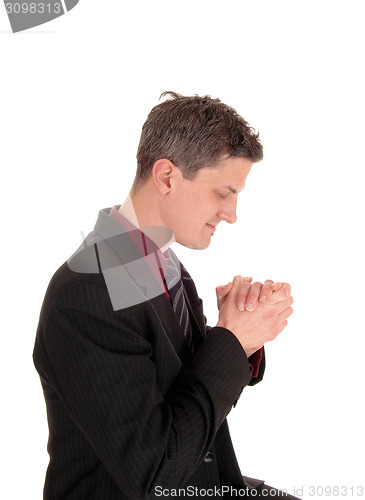 Image of Praying businessman.