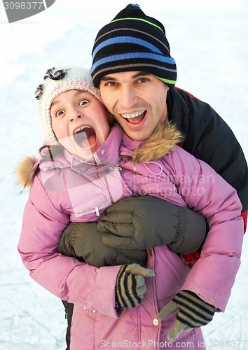 Image of Dad hug his daughter and have fun in winter park