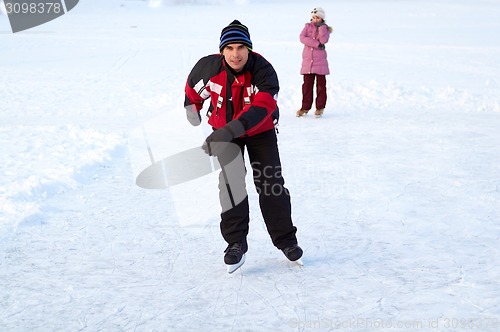 Image of Happy family on skating rink outdoors