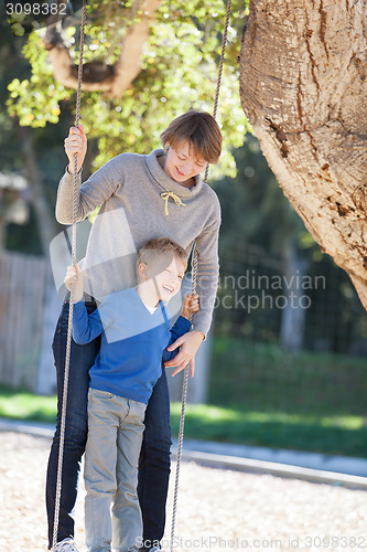 Image of family at swings