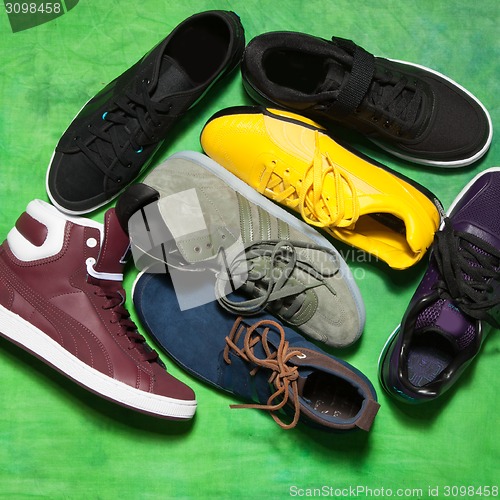 Image of Set of man footwear on a green background