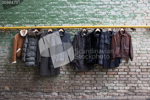 Image of Men's trendy clothing on hangers