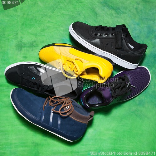Image of Set of man footwear on a green background