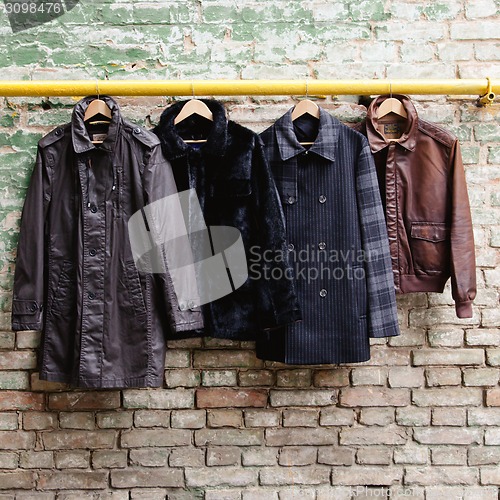 Image of Men's trendy clothing on hangers