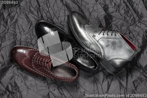 Image of Set of man footwear on a black background