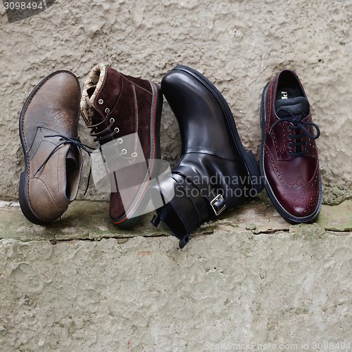 Image of Set of man footwear on a grunge  background