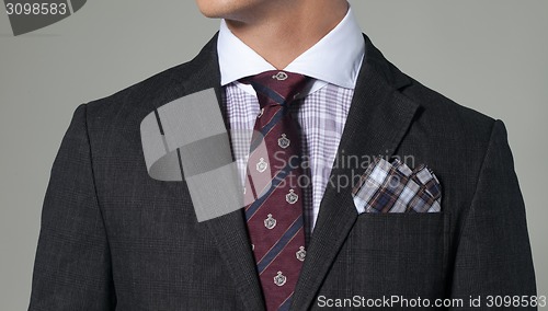 Image of man in suit on a dark background