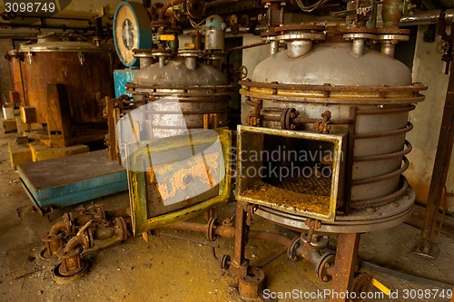 Image of Industrial containers in abandoned interior