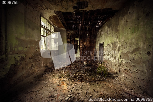 Image of Dark room interior with damaged roof