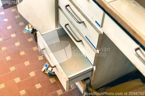 Image of Cupboard with opened empty drawer