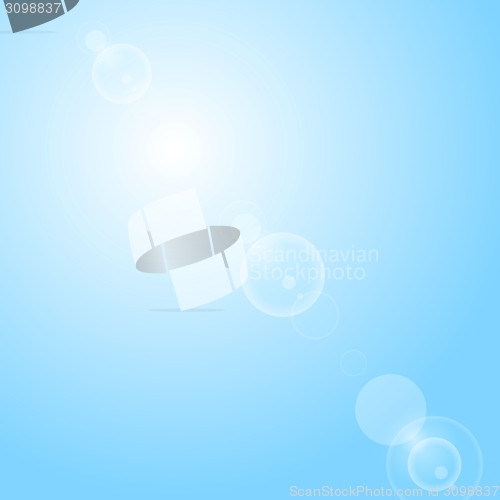 Image of Shiny lens flare on blue sky