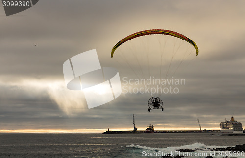 Image of Motorized Paraglider Flight above Ocean Harbor