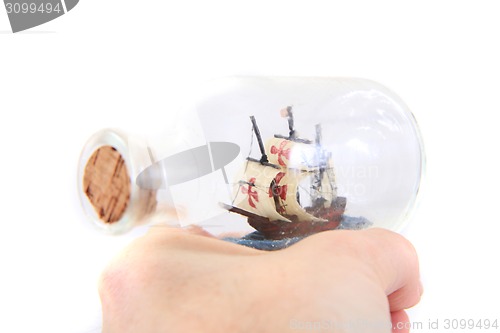 Image of small ship in human hand