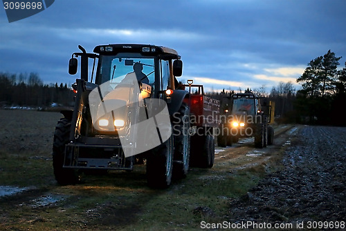Image of Two Agricultural Tractors on a Winter Night