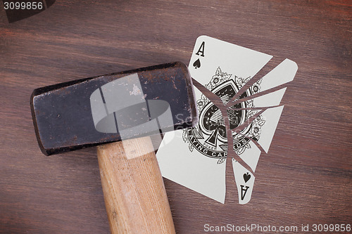 Image of Hammer with a broken card, ace of spades