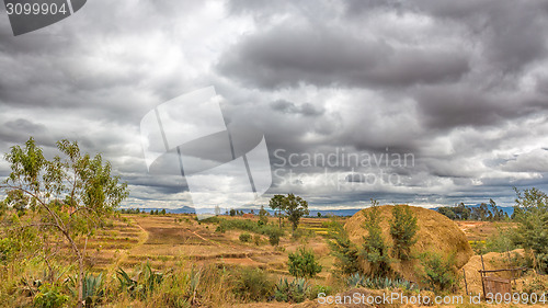 Image of Dark clouds hovering over the fields