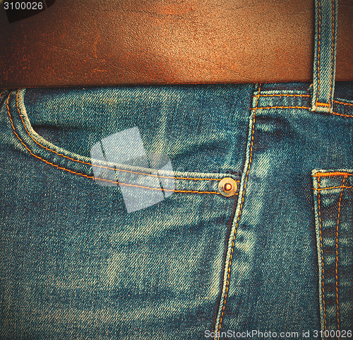 Image of blue jeans with belt, close up