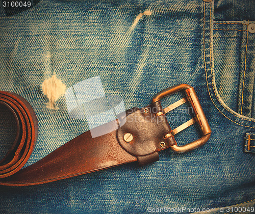 Image of vintage leather belt on old jeans