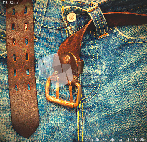 Image of aged jeans with unfastened belt