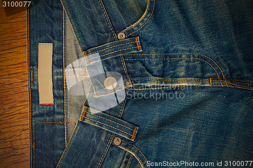 Image of indigo jeans with a button