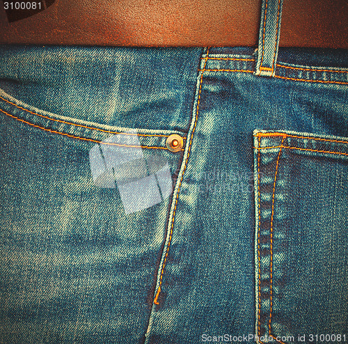 Image of jeans with a brown leather belt