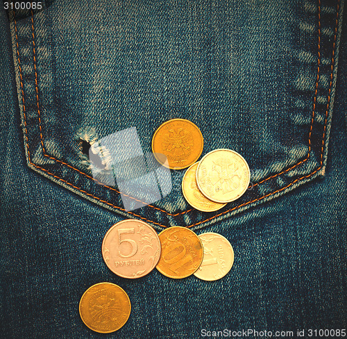 Image of pocket with hole and coins