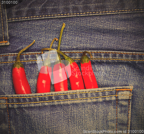 Image of hot chili peppers in a jeans pocket