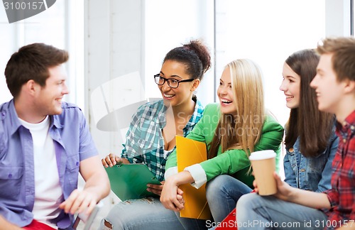 Image of students communicating and laughing at school