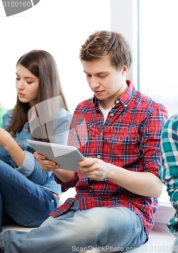 Image of student looking into tablet pc at school