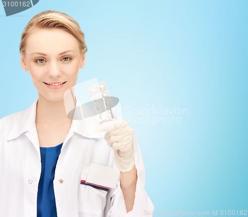 Image of happy female doctor with pills