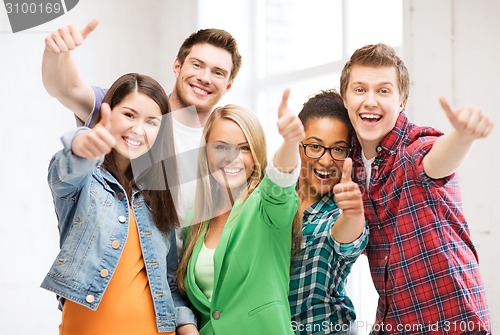 Image of students showing thumbs up at school