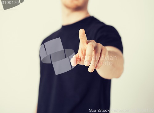 Image of man pointing his finger at you