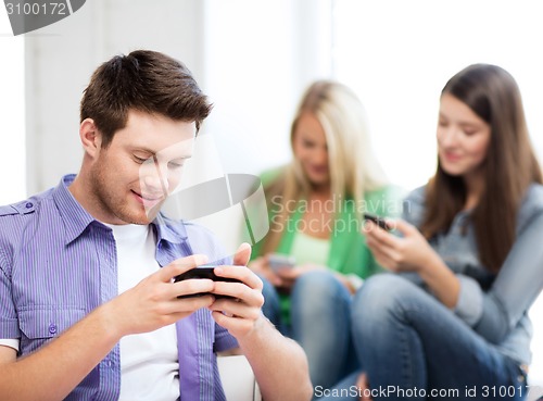 Image of students looking into devices at school