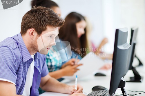 Image of student with computer studying at school