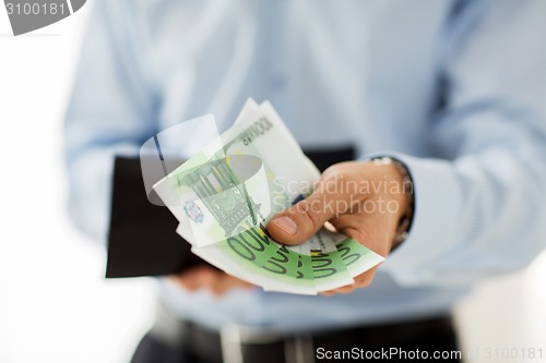 Image of close up of businessman hands holding money