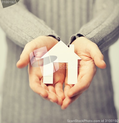 Image of man holding paper house