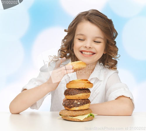 Image of happy smiling girl with junk food